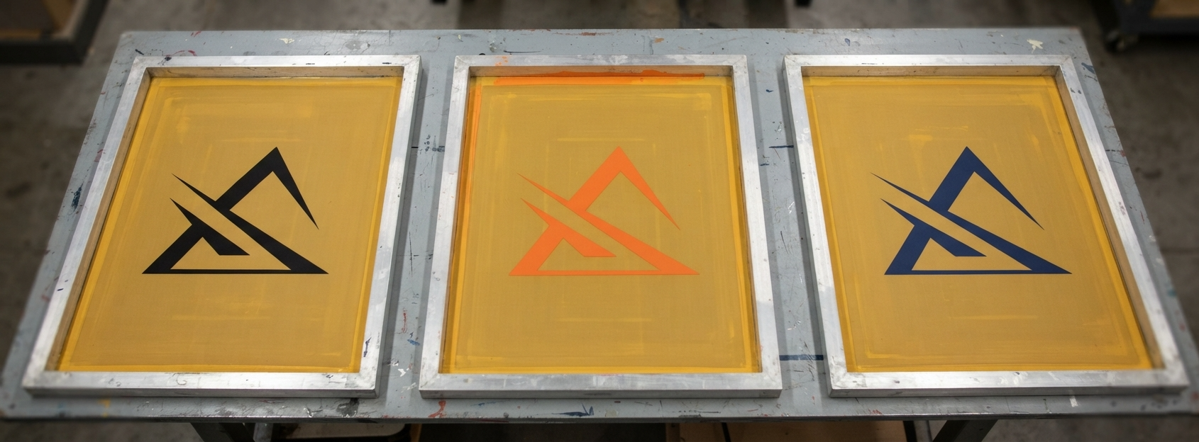 A logo separated into individual spot color layers, each shown on its own screen ready for burning